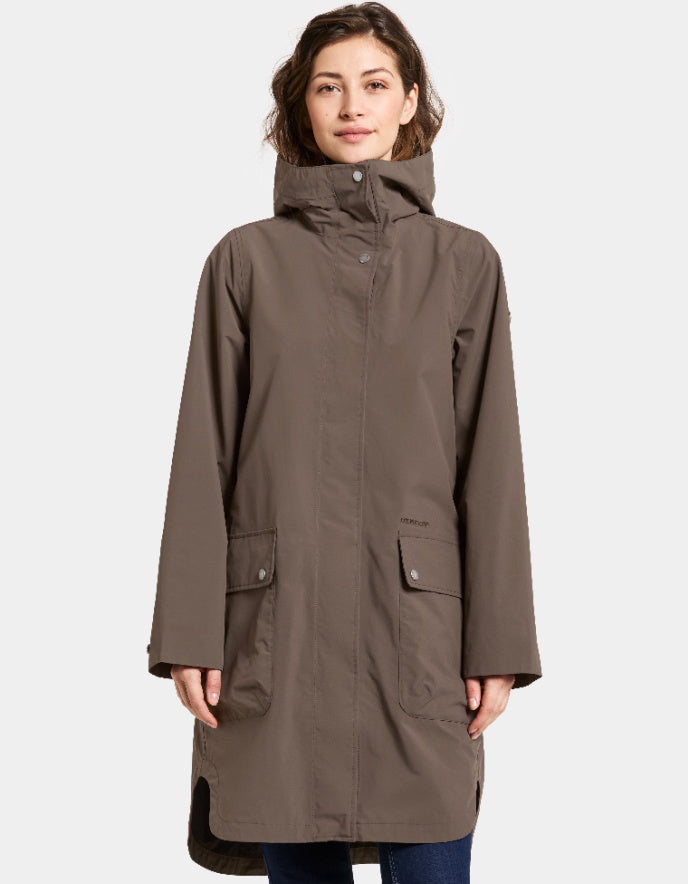 Woman wearing a mocha brown waterproof coat on a white background parka style