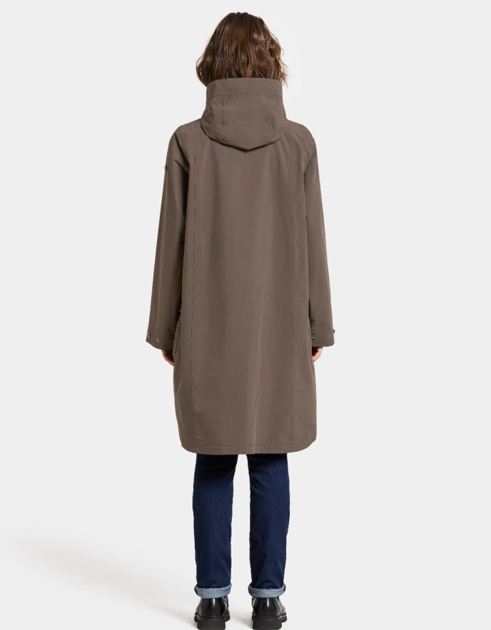 Woman wearing a mocha brown waterproof coat on a white background parka style