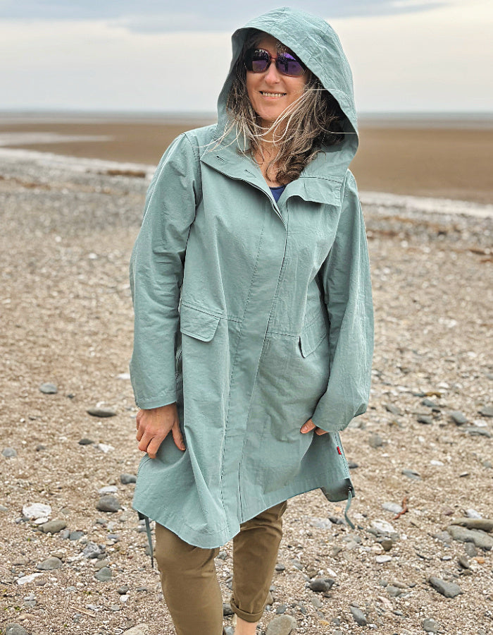 cotton hooded duster coat in soft duck egg blue, two front pockets and button front and pleated back for a swing shape