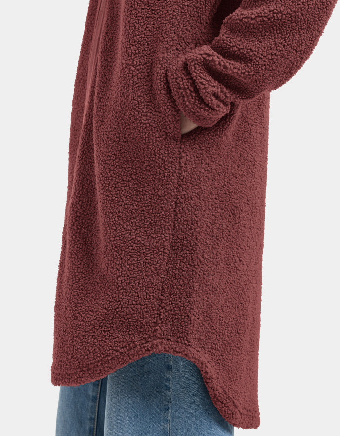 Woman wearing a long burgundy fleece sherpa pile coat on a white background jacket