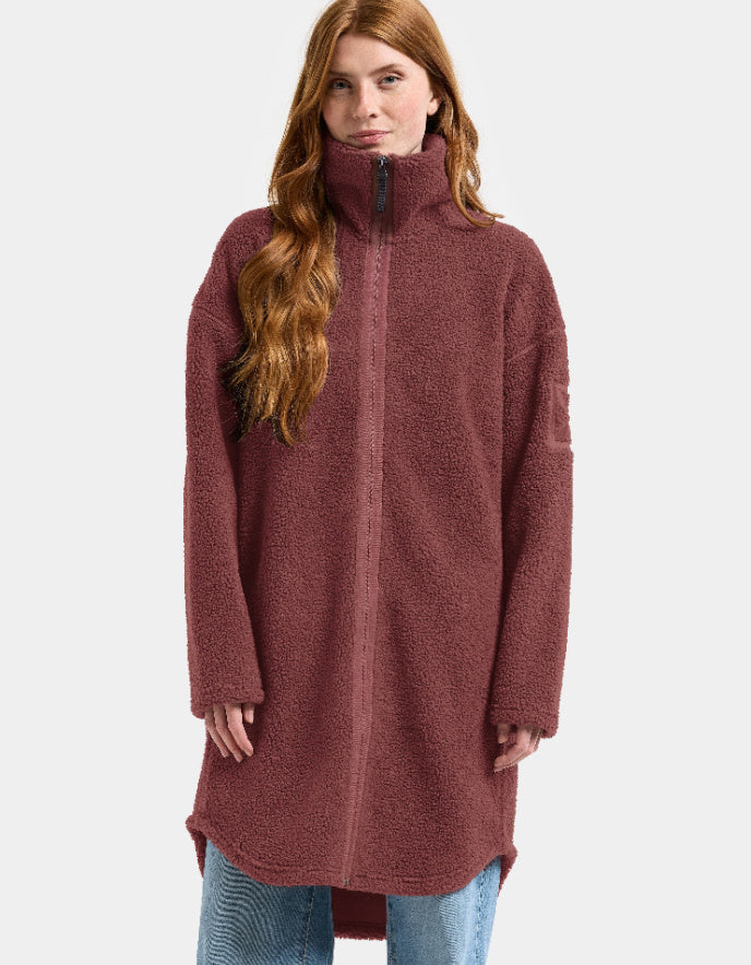 Woman wearing a long burgundy fleece sherpa pile coat on a white background jacket