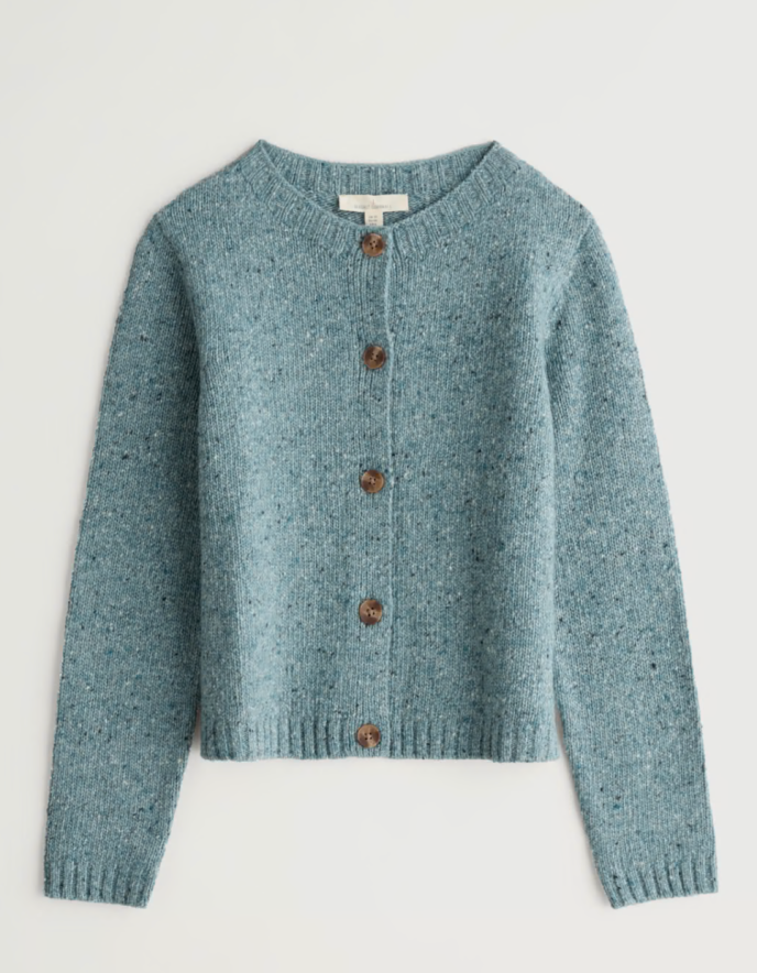 Blue knitted cardigan with brown buttons on a light gray background