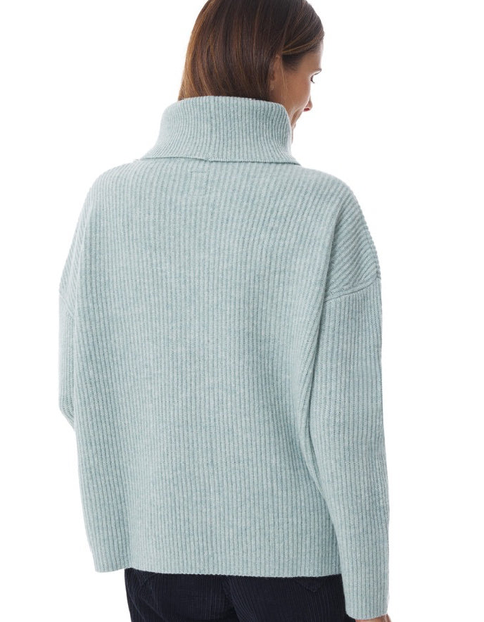Light blue ribbed sweater worn by a person on a white background