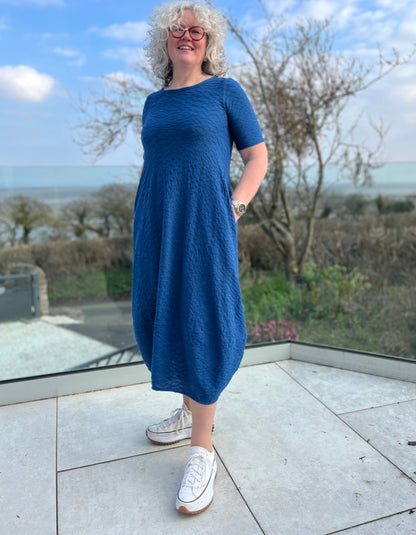 midi length blue jersey bubble dress with short sleeves and waffle texture and pockets