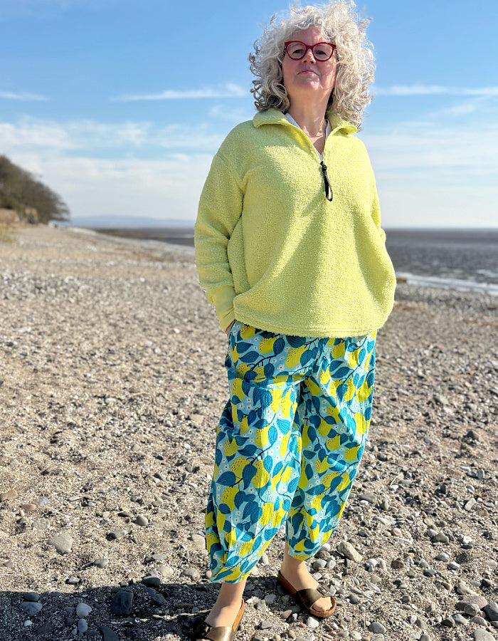 lantern shaped cotton summer trousers with apple print in turquoise and lime. elasticated waist and pockets and tie waist