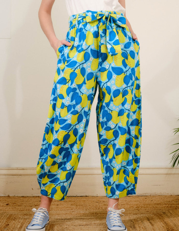 lantern shaped cotton summer trousers with apple print in turquoise and lime. elasticated waist and pockets and tie waist