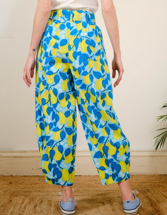 lantern shaped cotton summer trousers with apple print in turquoise and lime. elasticated waist and pockets and tie waist