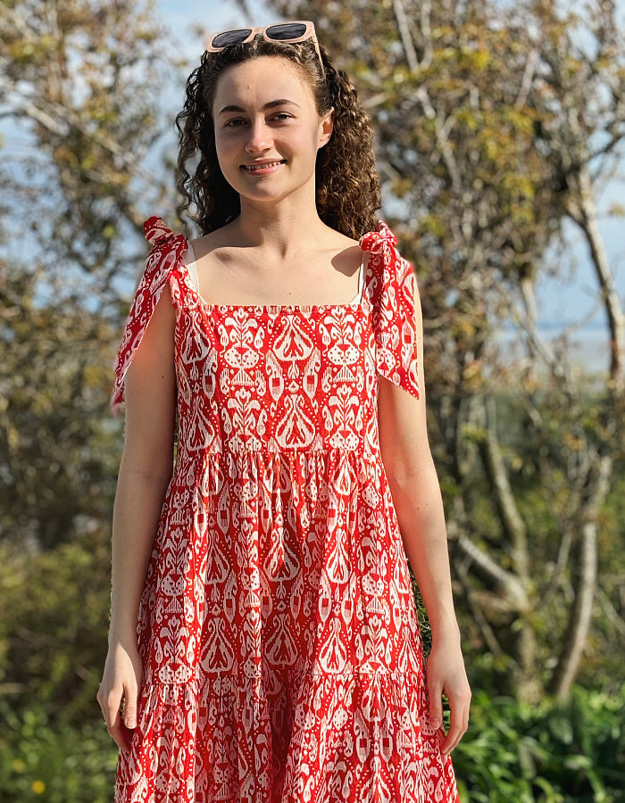 red and white hand block print cotton maxi dress with tie shoulder straps and a tiered skirt