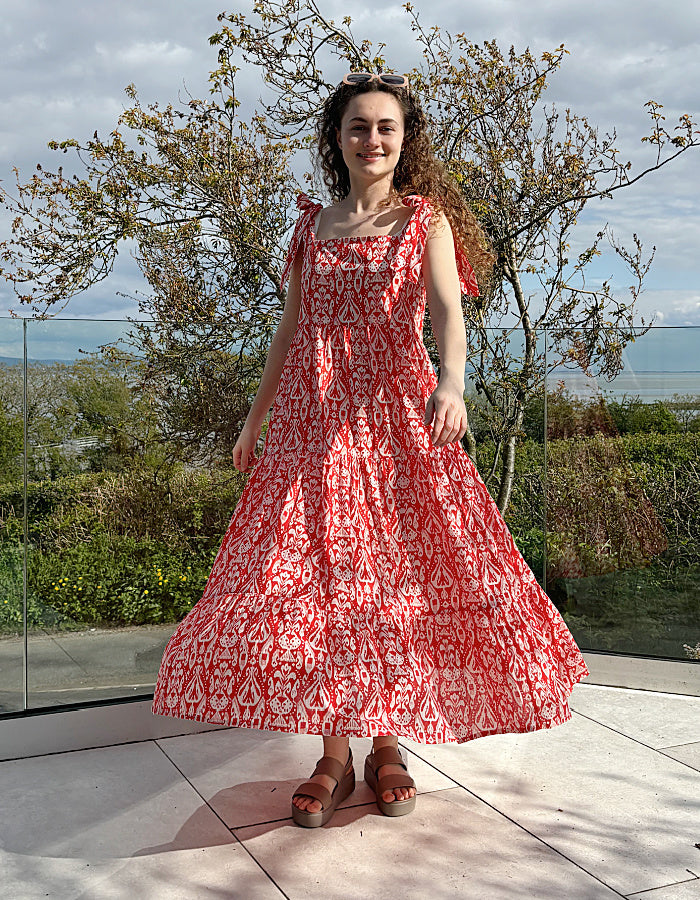 red and white hand block print cotton maxi dress with tie shoulder straps and a tiered skirt