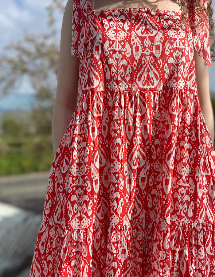red and white hand block print cotton maxi dress with tie shoulder straps and a tiered skirt