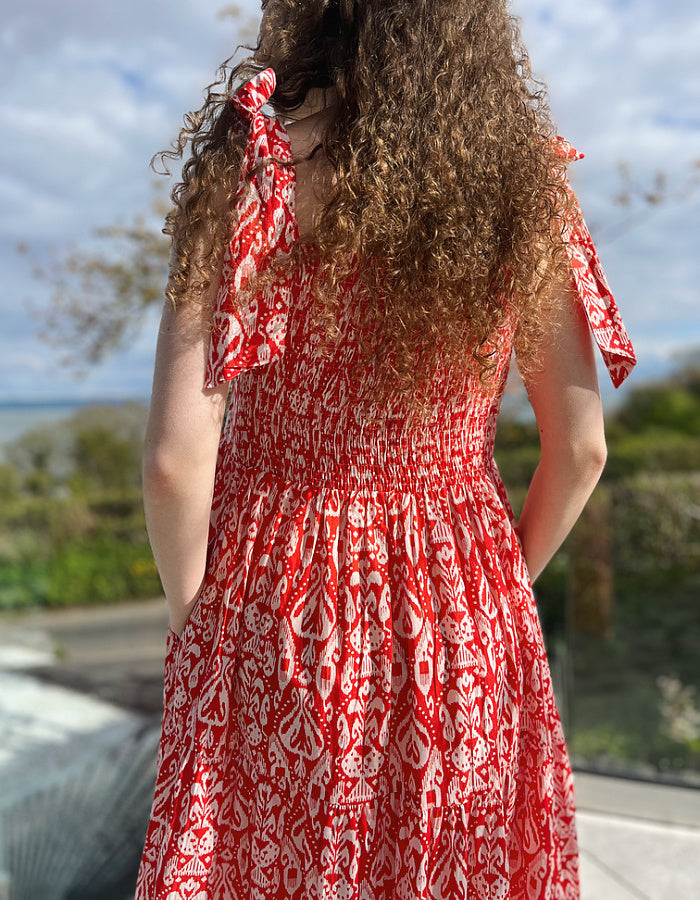 red and white hand block print cotton maxi dress with tie shoulder straps and a tiered skirt