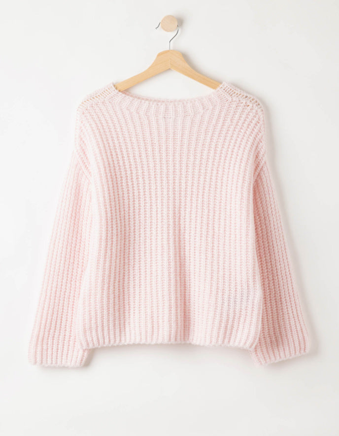 woman wearing pale pink ribbed knitted sweater