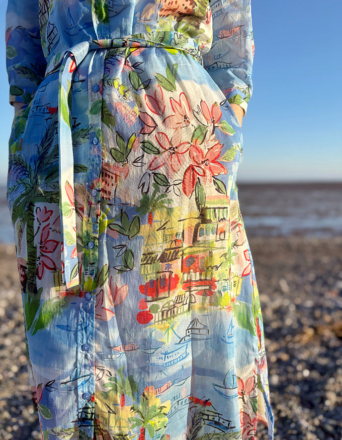 Colourful floral and architectural patterned dress on a beach