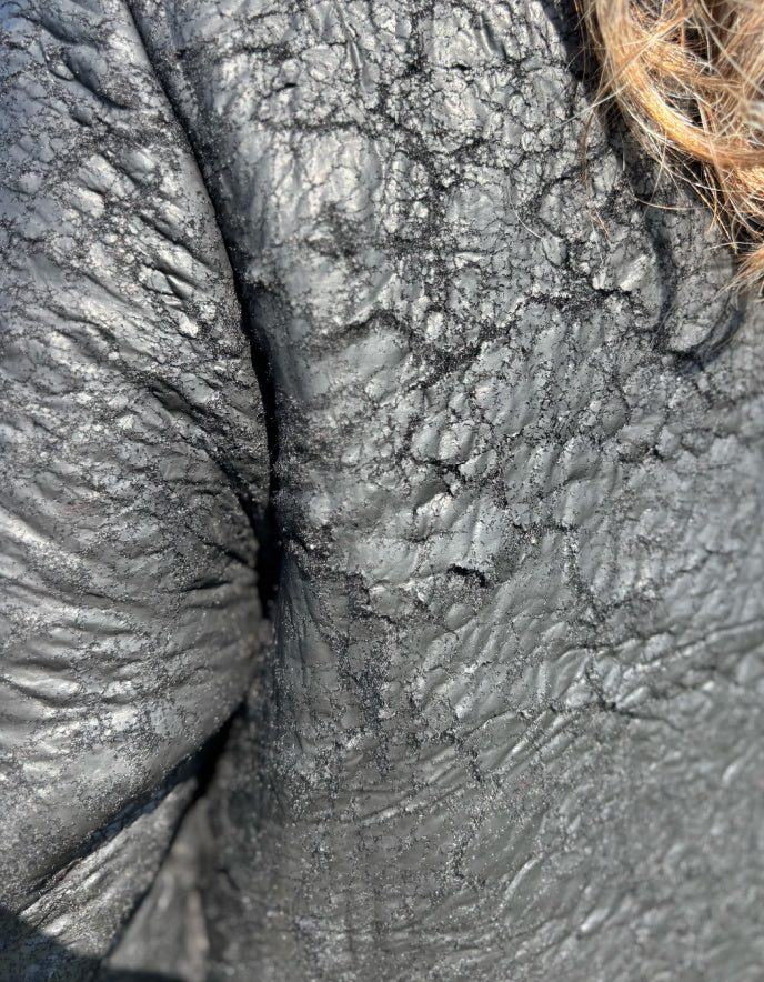 close up of distressed detail of black fabric