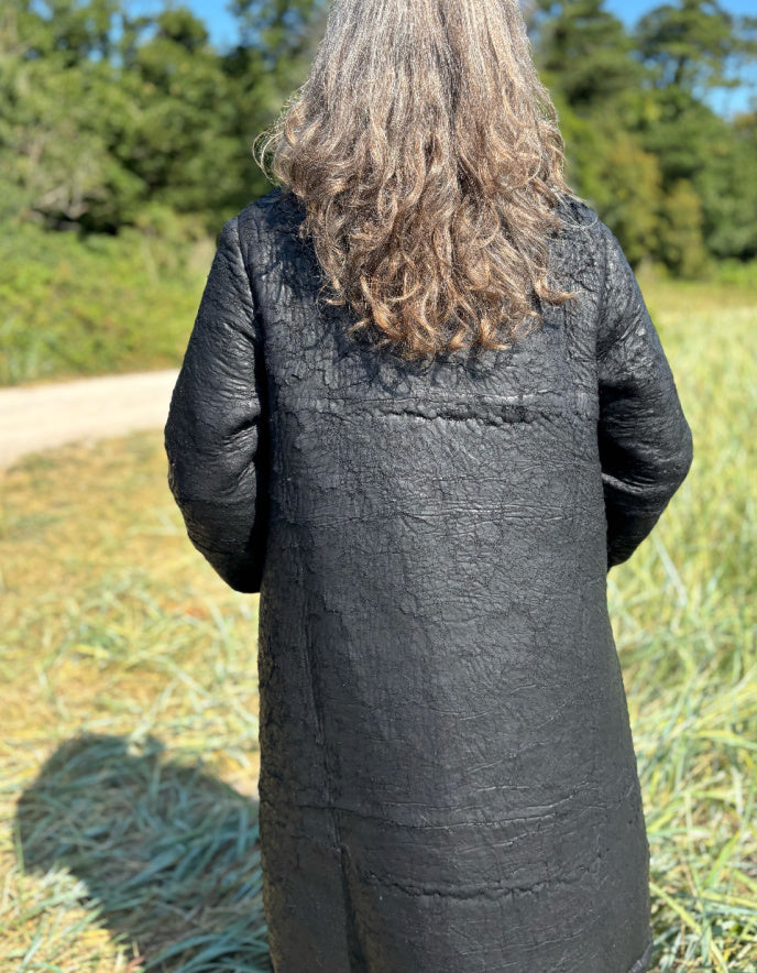 woman wearing black winter coat with distressed finish