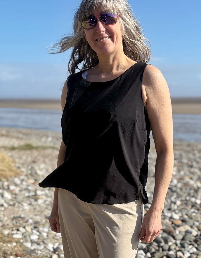 woman wearing black tank top on a beach
