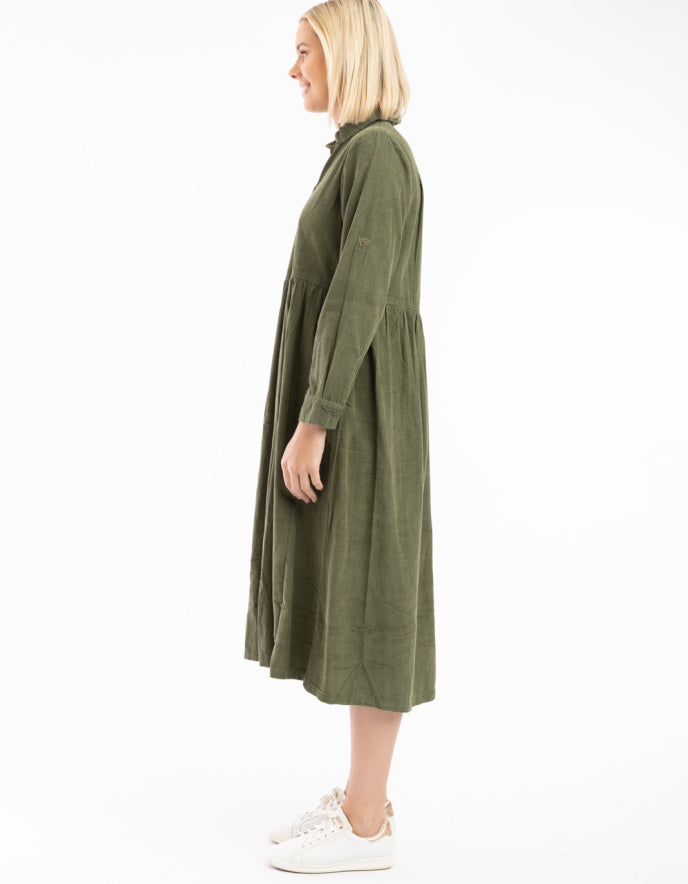 Woman wearing a green dress on a white background