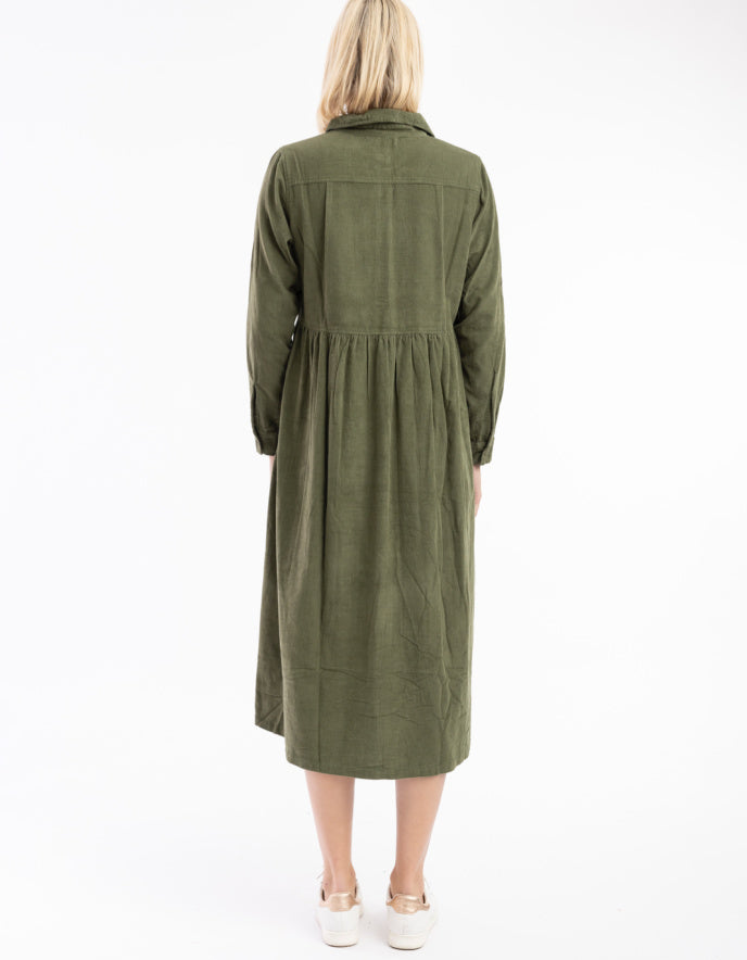 Woman wearing a green dress against a white background