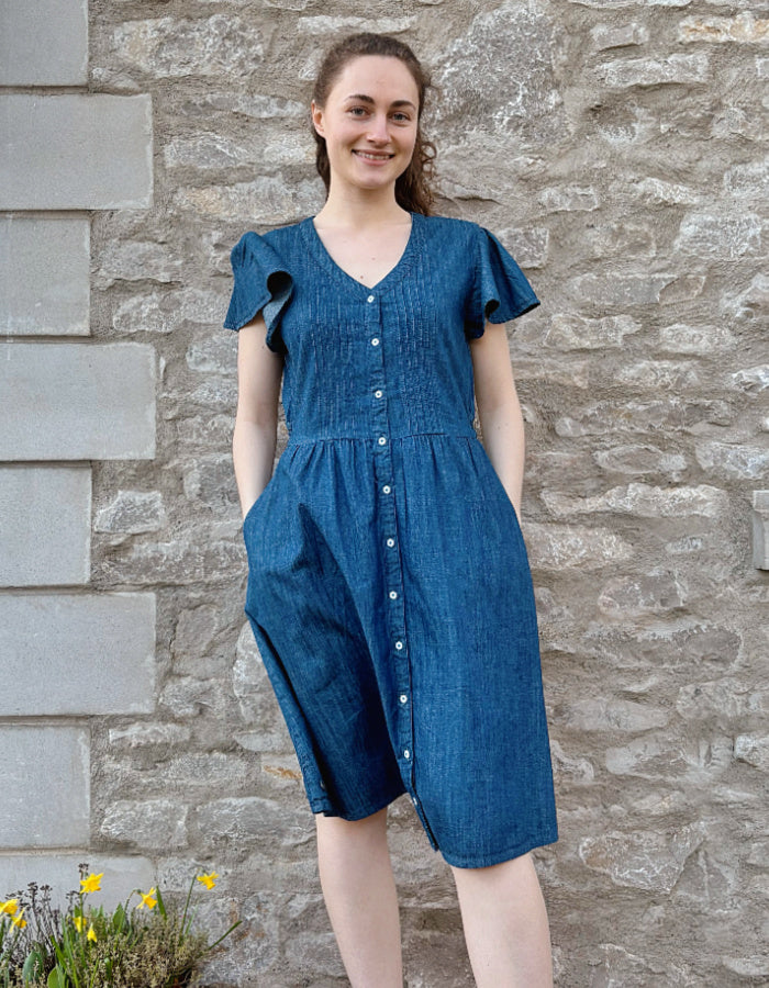 knee length denim dress with neckline, button through at the front and fluted sleeves, gathered waist. everyday dress