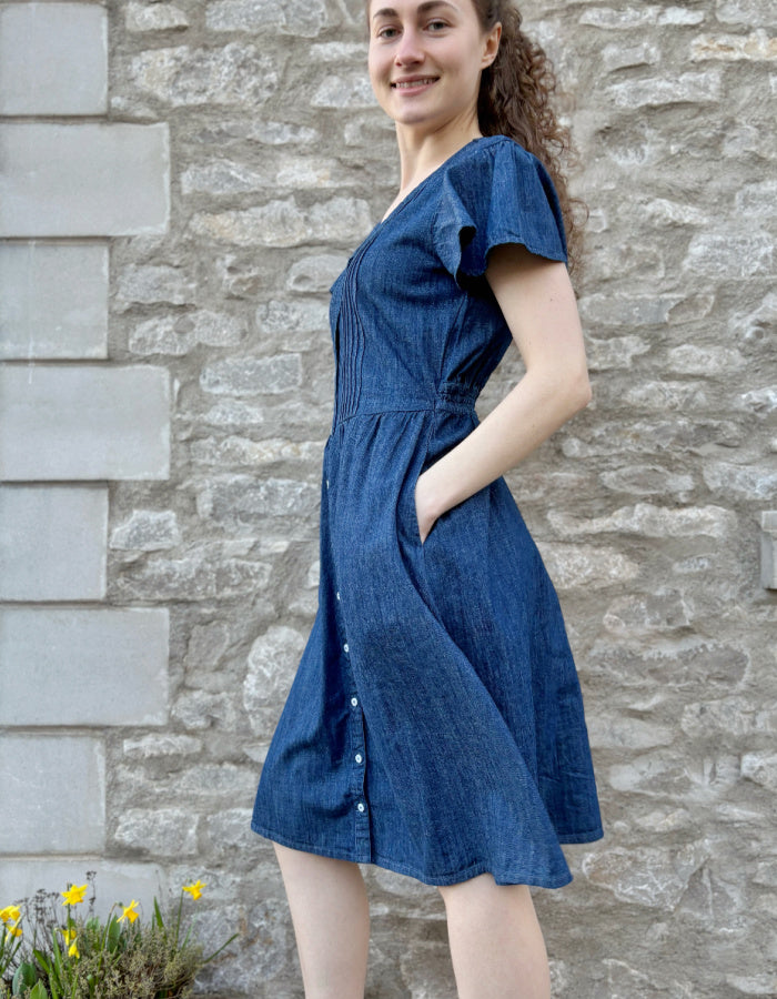 knee length denim dress with neckline, button through at the front and fluted sleeves, gathered waist. everyday dress