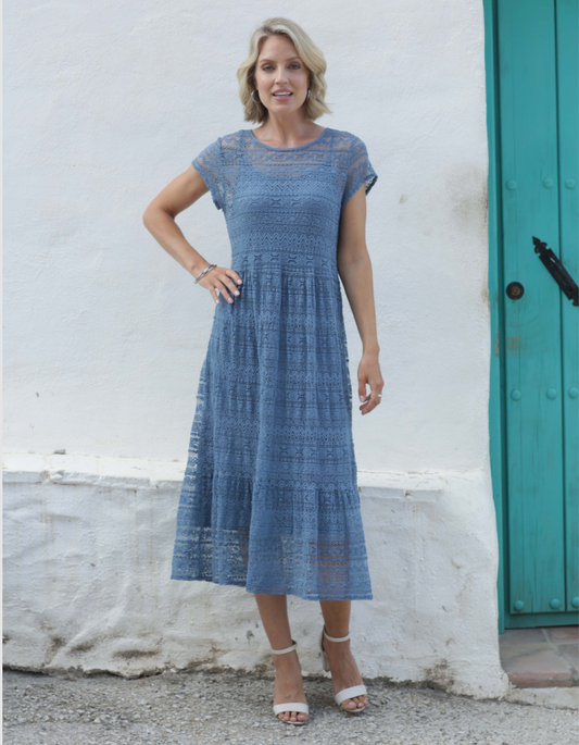 midi length laced dress with empire line and capped sleeves, slash neckline in denim blue