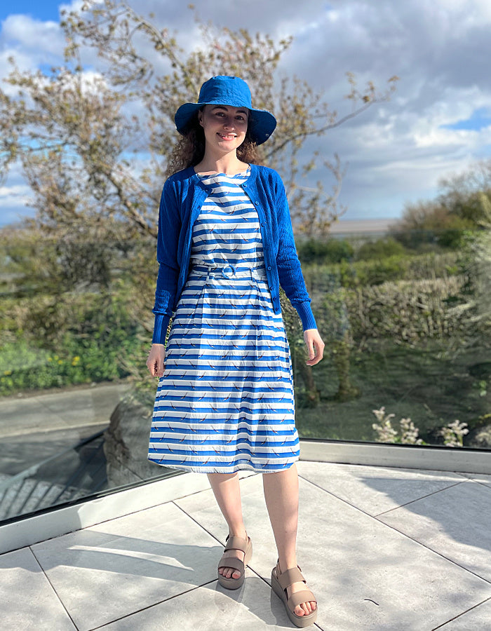 fit and flare sleeveless dress with blue and white striped with swimmers print, includes waist belt and pockets