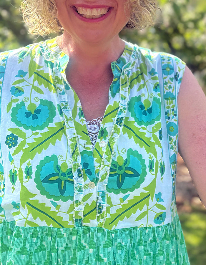 maxi length tiered sleeveless dress with a 70's retro vibe with a green and lime graphic floral print