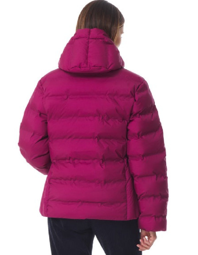 Person wearing a bright pink puffer jacket on a white background