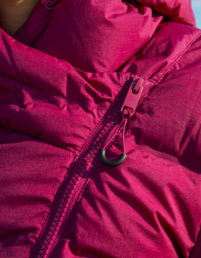 Close-up of a pink puffer jacket with a zipper
