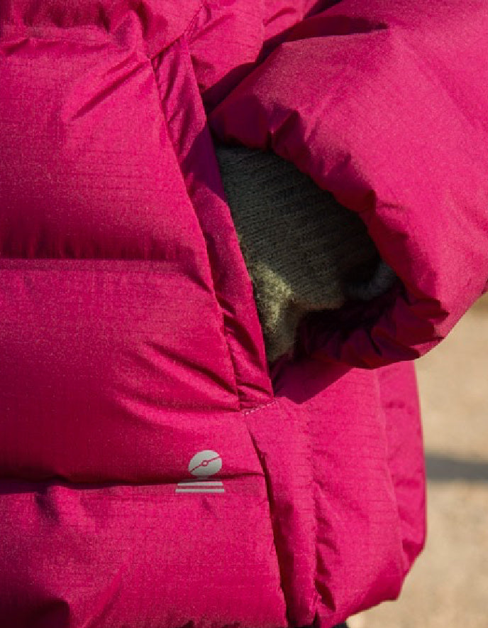 Close-up of a pink puffer jacket with a brand logo on a blurred background