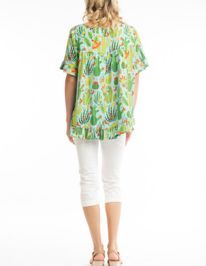 loose fit summer top with scoop neckline and fried edges in lime green with bright print with chillis and cacti and sombreros