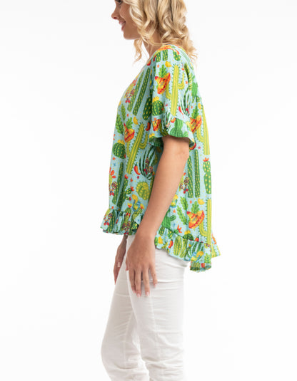 loose fit summer top with scoop neckline and fried edges in lime green with bright print with chillis and cacti and sombreros