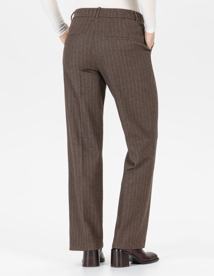 Brown pin stripe pants worn by a person on a white background
