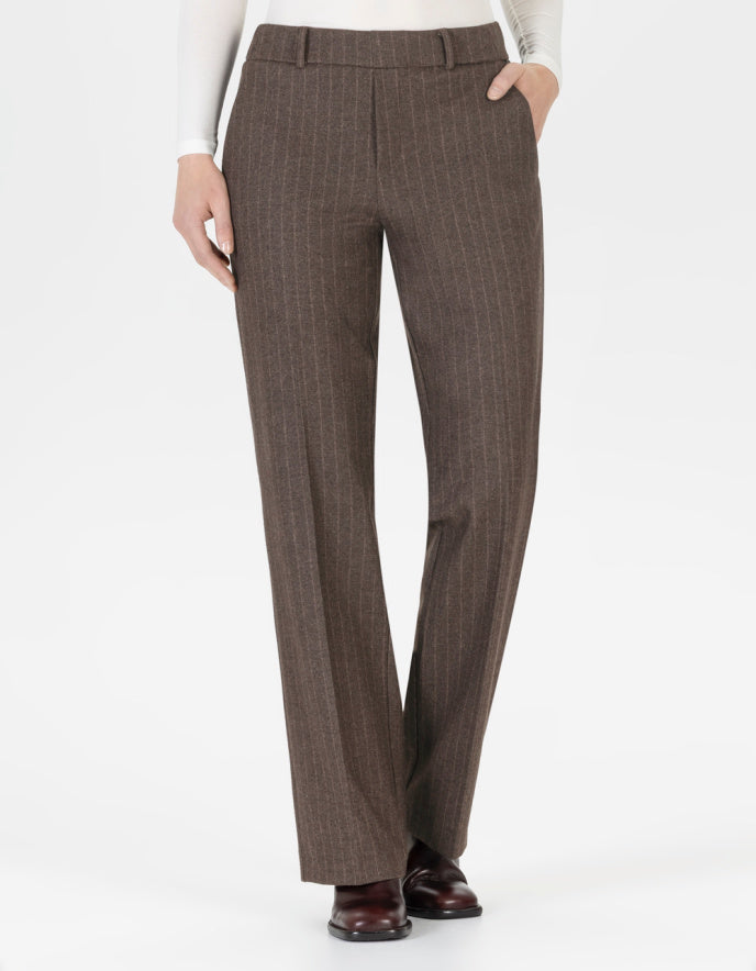 Brown pin stripe pants worn by a person on a white background