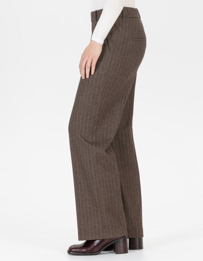 Brown pin stripe pants worn by a person on a white background