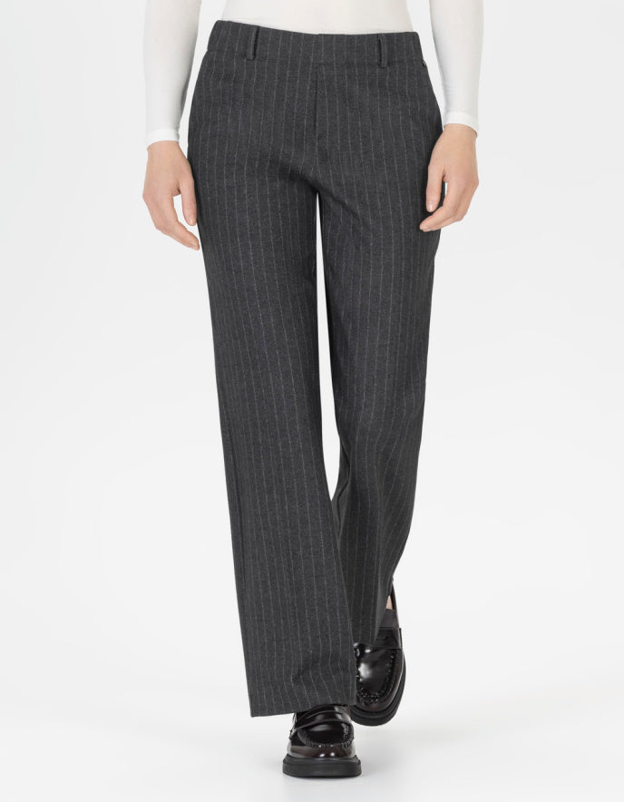 Grey pinstripe pants worn by a person on a white background