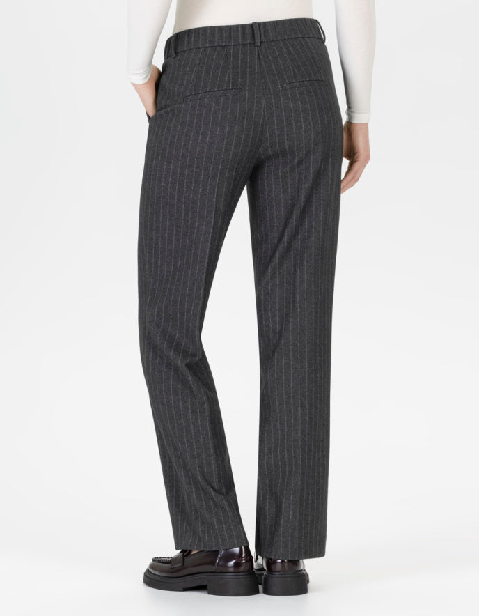 Grey pinstripe pants worn by a person on a white background