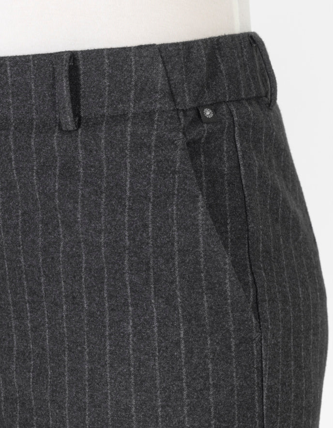 Grey pinstripe pants worn by a person on a white background