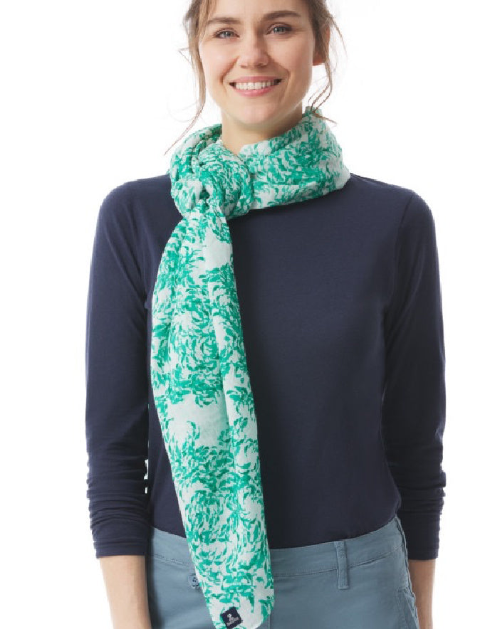 Woman wearing a teal floral scarf on a white background
