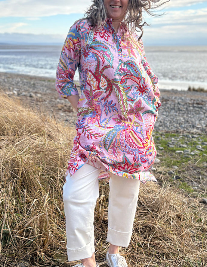 woman wearing a rose print cotton shirt dress over cream jeans