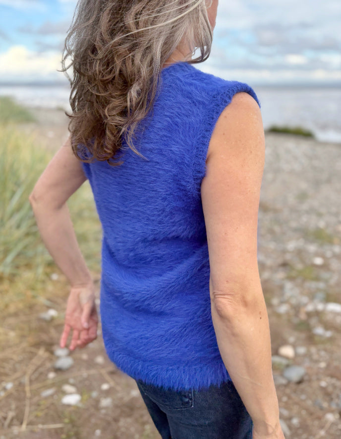 woman wearing cobalt blue fluffy V neck tank top and jeans