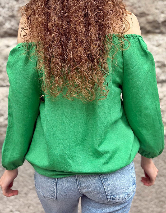 green linen top with elasticated scoop neckline that can be worn off shoulder and adjustable was it. with 3/4 length sleeves