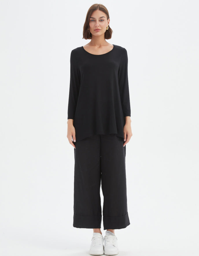 Woman wearing a black outfit on a white background