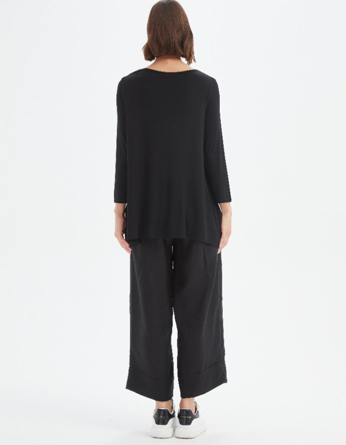 Person wearing a black outfit on a white background