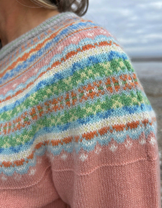 woman wearing peach fair isle cardigan