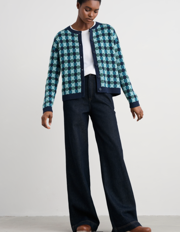 Person wearing a blue and green patterned cotton cardigan over a white shirt.
