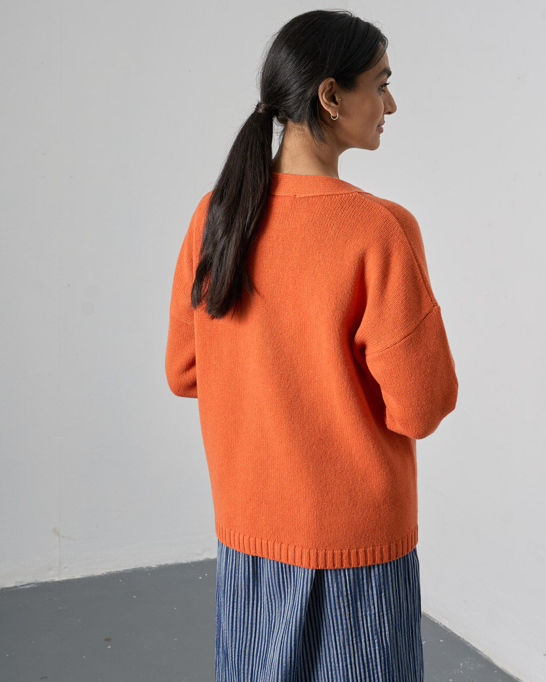 woman wearing orange boyfriend wool cardigan