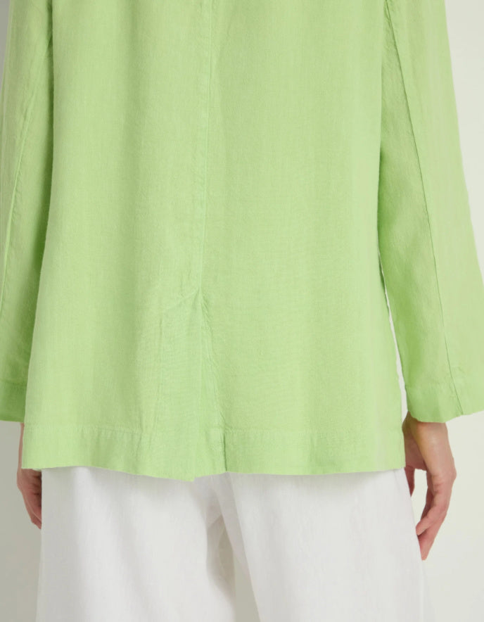 Light green jacket worn by a person on a white background