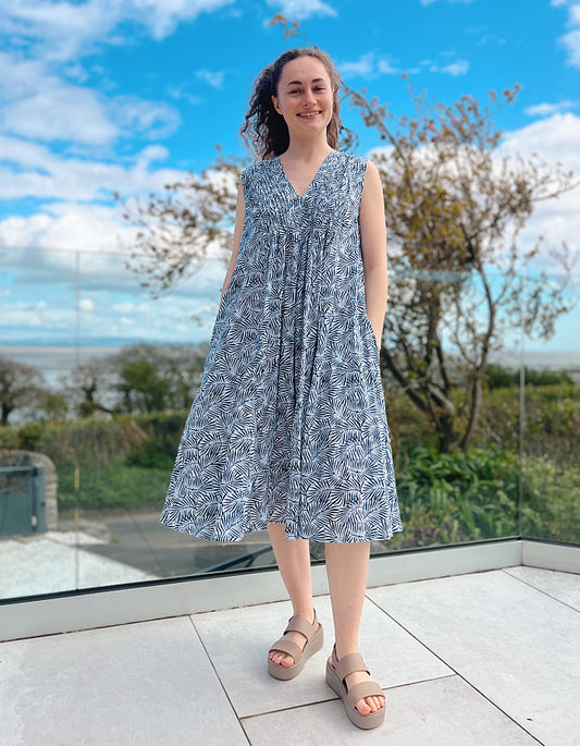 swing shape midi cotton summer dress with crinkle tie effect, white and blue leaf print and V neckline with pleated bodice