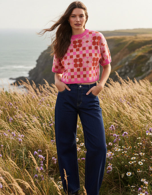 woman wearing a checkerboard and flower pink and red tank top sweater